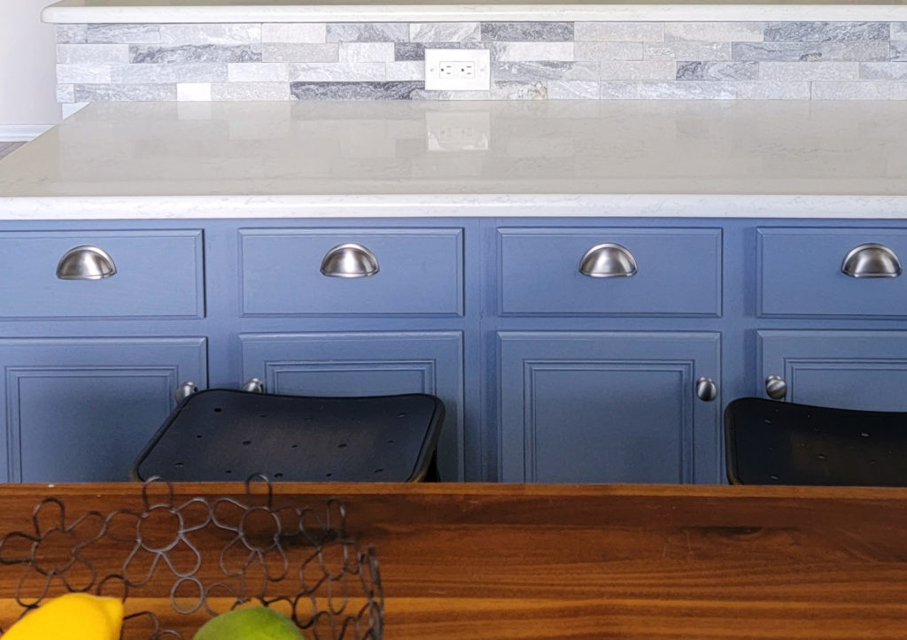 Benjamin Moore Bachelor Blue on painted wood cabinets with white quartz and backsplash tile. Kylie M Interiors CLIENT PHOTO