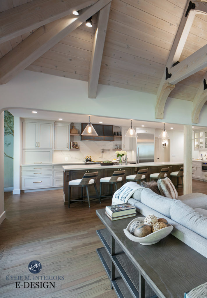 Benjamin Moore White Dove walls, Open concept living family room, kitchen, vaulted wood frame beam ceilings, soapstone surround fireplace with tv above, red oak wood floor. Kylie M Interiors