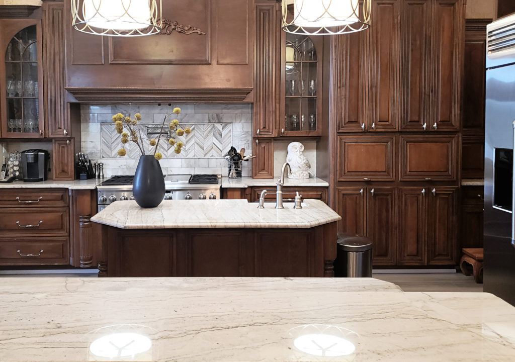 Dark wood cabinets with modern granite or light quartz countertop.