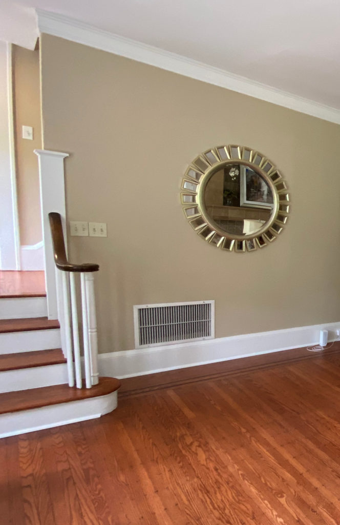 Shaker Beige in living room, orange toned wood floor, white trim, Client photo for Kylie M Interiors Edesign. Best beige paint colour