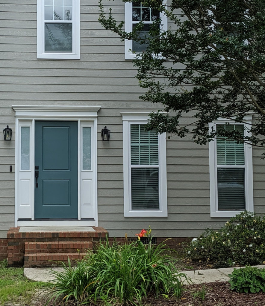 Sherwin Williams Riverway, teal, blue-green front door paint colour with Extra White trim and warm gray greige siding. Client photo, Kylie M Interiors