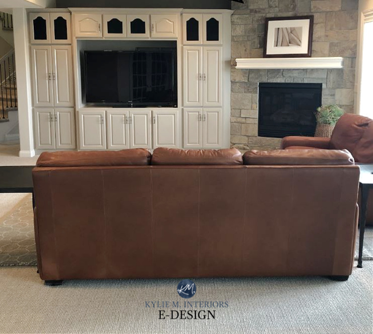 Tobacco cognac brown leather sofa, stone fireplace, oak built-ins painted Sherwin Williams Mega Greige. Kylie M Interiors Edesign