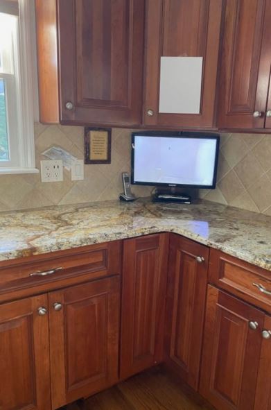 Cherry or maple kitchen cabinets, soon to be painted warm white. Warm granite countertops from 90s. Kylie M Interiors kitchen update ideas. Travertine style backsplash