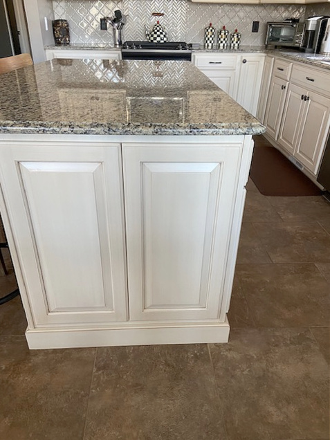 Closeup of Venetian Gold granite countertop with glazed cream Sherwin Williams painted cabinets and beige tile floor. CLIENT PHOTO, Kylie M INteriors Edesign