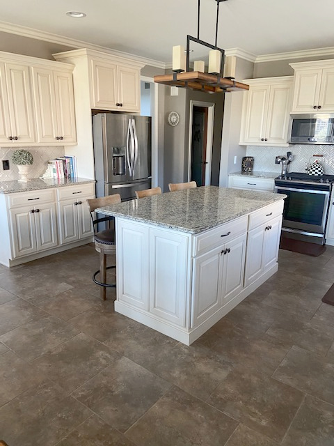 Dover White, cream cabinets with glaze, greige taupe walls with beige flooring and granite Venetian countertops, taupe backsplash. CLIENT PHOTO, Kylie M INteriors Edesign