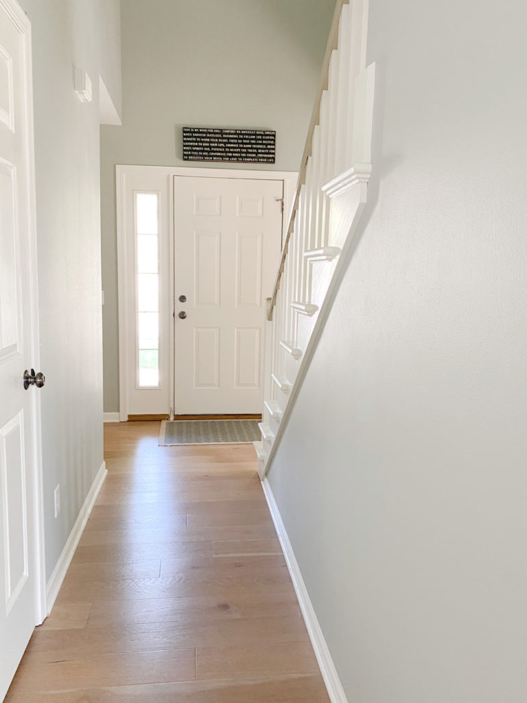 Foyer and hallway warm toned oak floor, best green gray, Sherwin Williams Austere Gray, Pure White trim and front door. CLIENT PHOTO Kylie M Interiors edesign