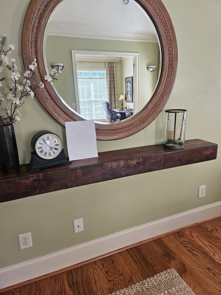 GREEN PAINT COLOR ON WALLS, SOFT WHITE TRIM, FLOATING SHELF, MEDIUM-TONED BROWN OAK FLOOR