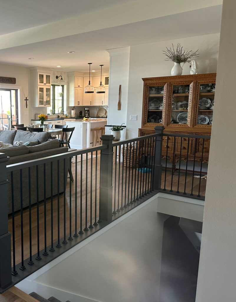 Sherwin Williams Urbane Bronze painted wood stair railing, wood floor, Glacier cabinets, Sherwin Williams White Duck paint color on walls, Pure White trim.