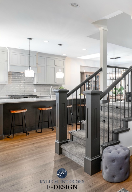Kitchen with warm gray cabinets Revere Pewter, painted island, white oak flooring staircase with painted hand railins and carpet. Kylie M Interiors E-design, online paint colour consulting