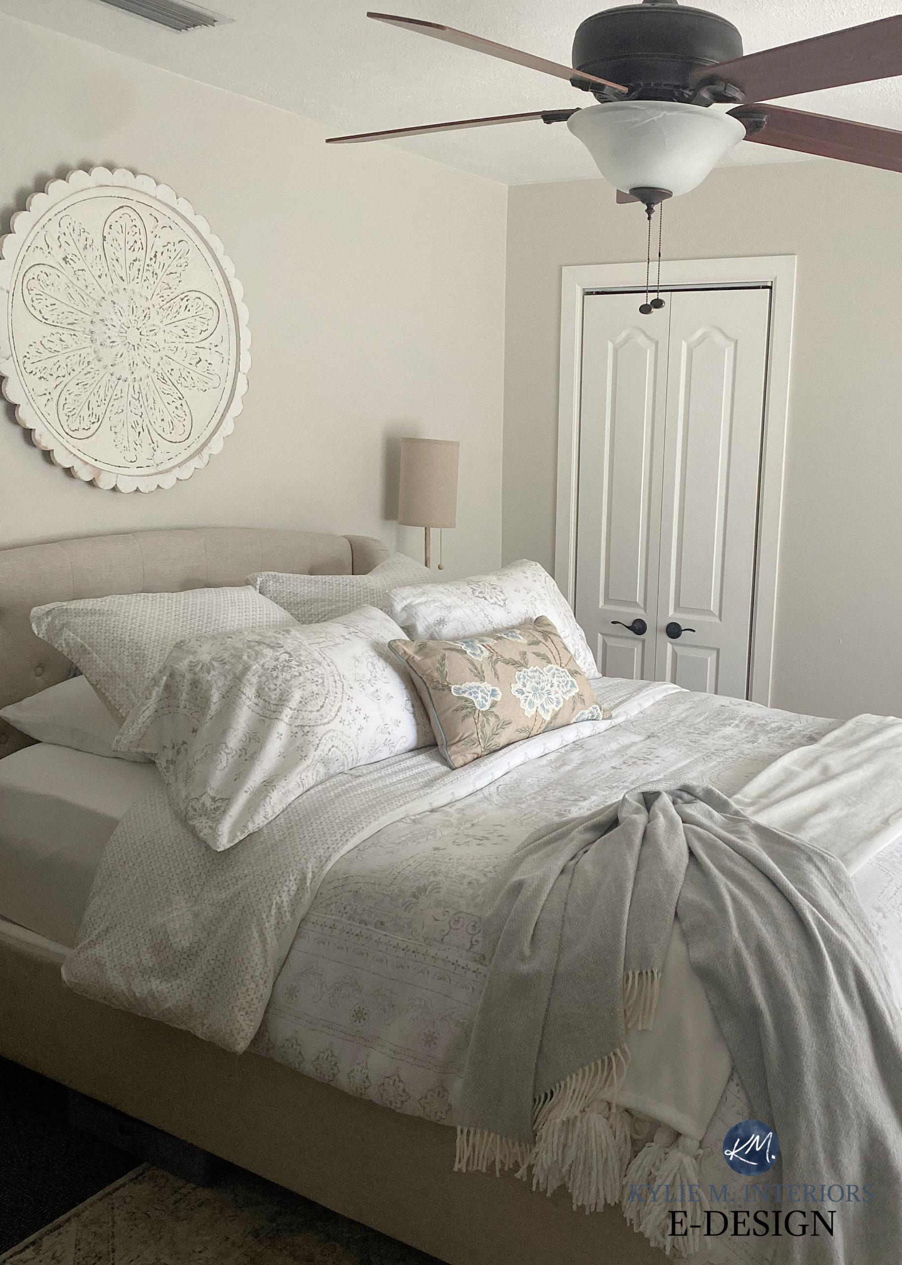 Transitional style primary bedroom with Sherwin Williams Egret White paint color on walls. Warm grey, taupe greige. ceiling fan. Kylie M Interiors Edeign