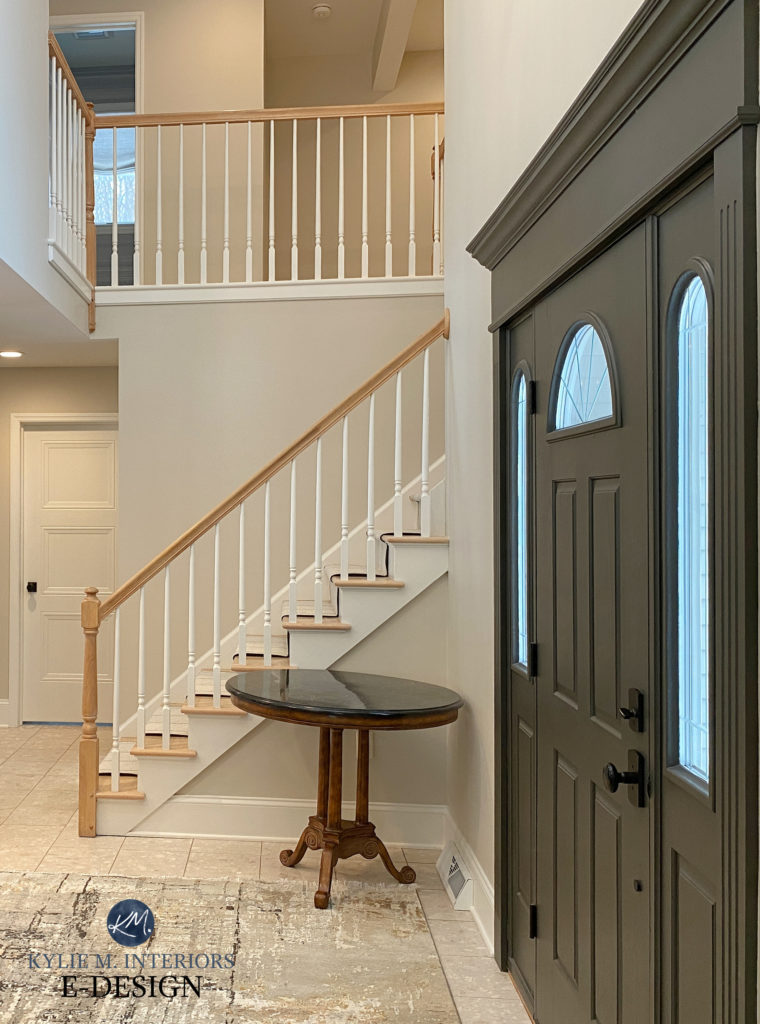 Benjamin Moore Edgecomb Gray paint color on walls, Cloud White trim, Sherwin URbane Bronze front door with beige toned tiles, foyer with oak hand rail, white spindles, Kylie