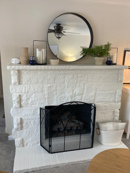 Painted stone fireplace with Sherwin Williams Canvas Tan on walls, White Dove stone, home decor on mantel. Kylie M Interiors Edesign