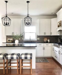 Painted white kitchen cabinets, black granite countertop, beige taupe backsplash tile, Sherwin Williams Alabaster cabinets, Kylie M and Jenna Christian