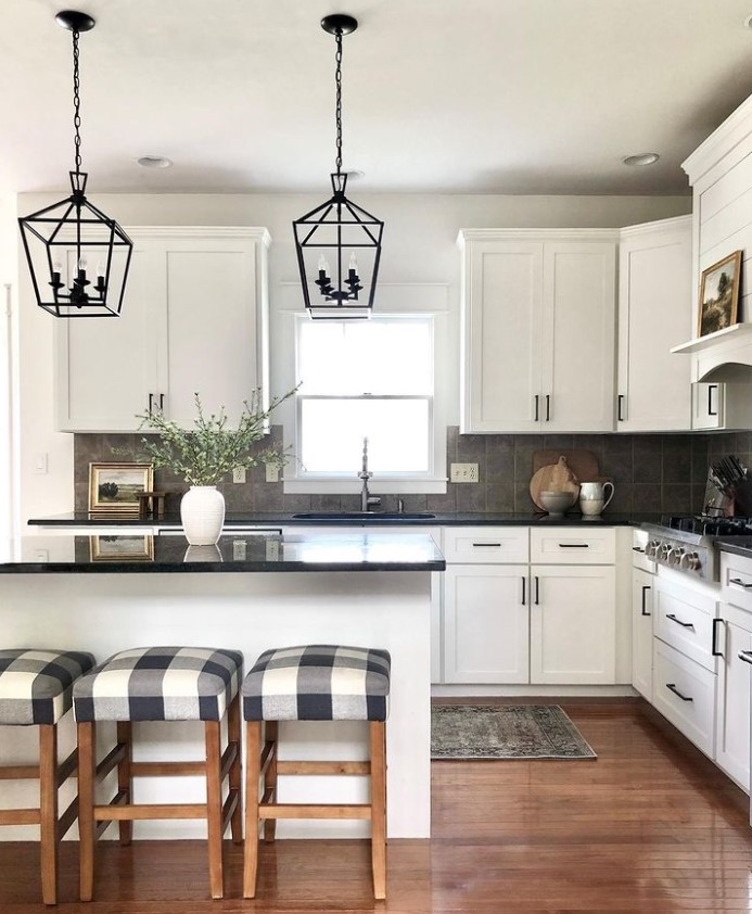 https://www.kylieminteriors.ca/wp-content/uploads/2022/03/Painted-white-kitchen-cabinets-black-granite-countertop-beige-taupe-backsplash-tile-Sherwin-Williams-Alabaster-cabinets-Kylie-M-and-Jenna-Christian.jpg