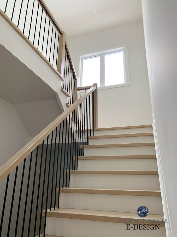 Staircase, wood hand railing, black metal spindles, white risers wood treads, BEnjamin Moore White Dove walls and trim. Kylie M Interiors Edesign