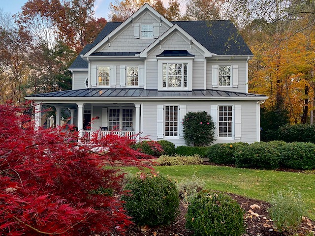 Exterior with gray siding, white trim, gray black roof, white porch. Sherwin Williams Knitting Needles, best gray paint colour. Kylie M Edesigns