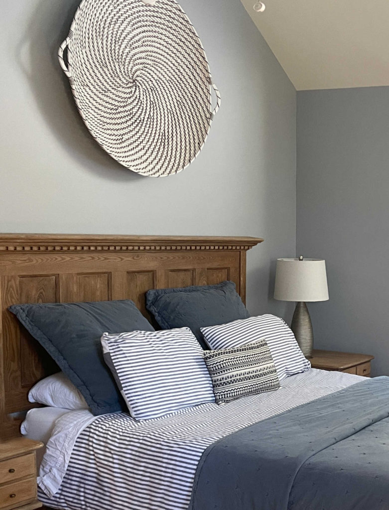 Benjamin Moore Coventry Gray, popular grey paint colour, bedroom with gray blue linens, wood headboard. Kylie M Interiors client photos