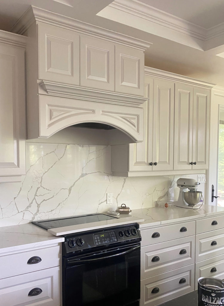 Sherwin Williams Modern Gray painted kitchen cabinets, off white taupe greige with white quartz marble look countertop. Kylie M