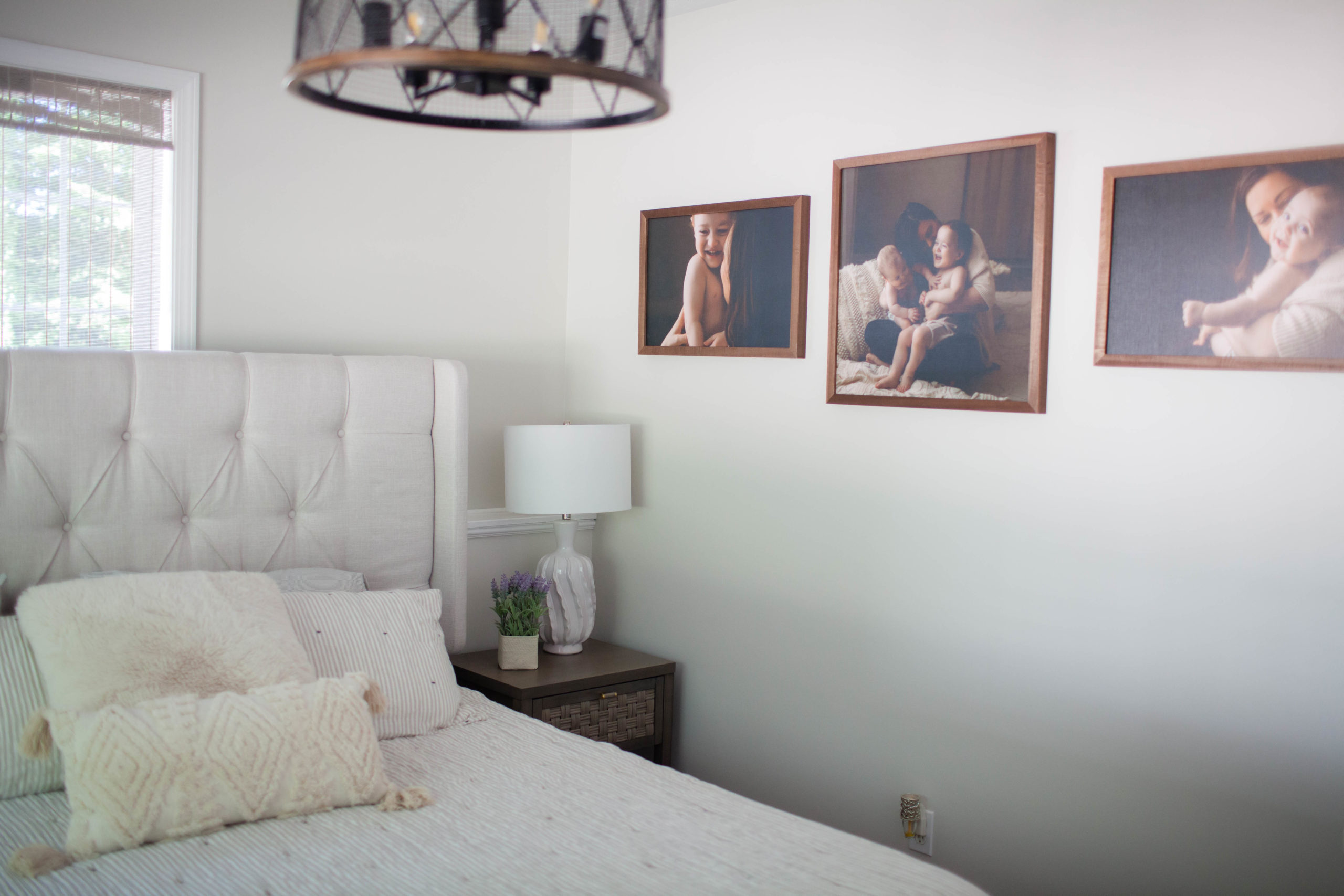 Sherwin Williams Aesthetic White in bedroom with neutral bed linens, home decor, gallery wall. Kylie M client photo