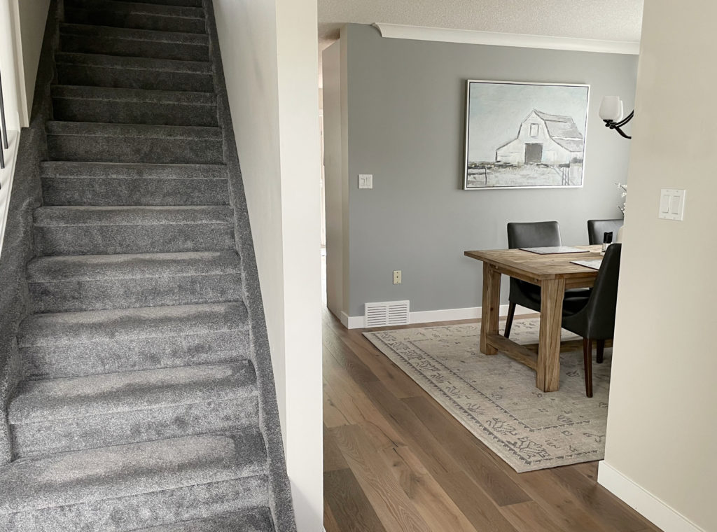 Sherwin Williams Ellie Gray, gray blue green paint color on walls. Gray carpet, wood floor. Kylie M Interiors