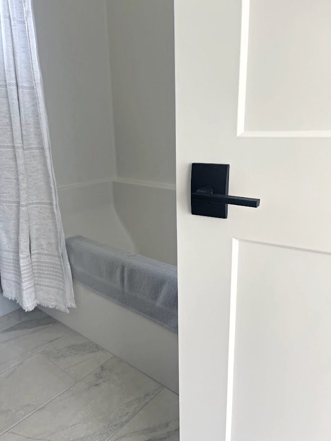 schlage door hardware, latitude lever, century trim on bathroom door painted White Dove