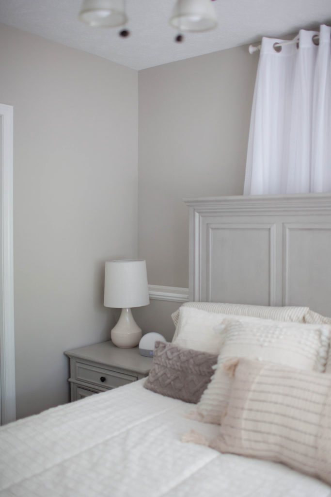 Sherwin Williams Agreeable Gray, best greige wall paint colour, taupe side table, neutral bed linens and home decor. Kylie M