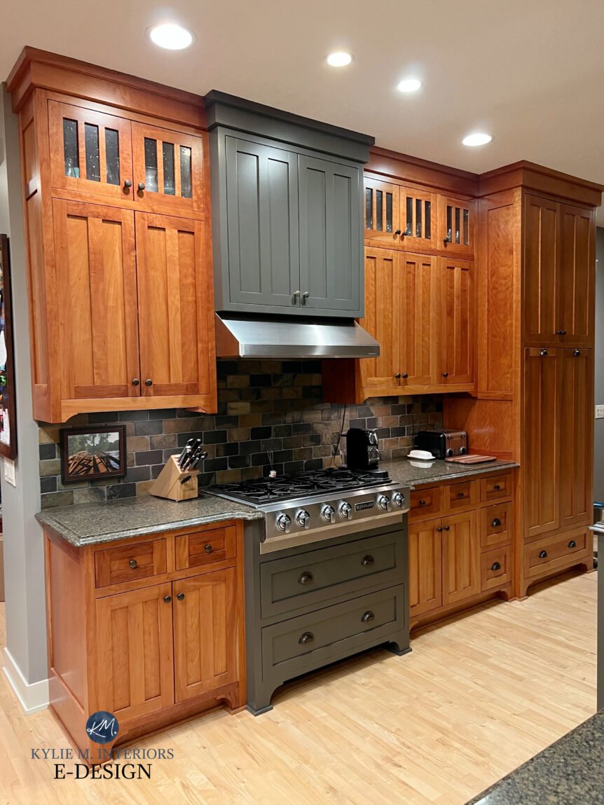 Cherry red stainedd wood cabinets with some cabinets painted Sherwin Williams Urbane Bronze - range hood. Granite countertop, slate tile backsplash. Kylie M Edesign