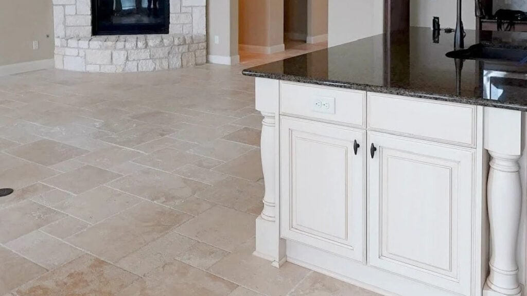 Sherwin Williams Antique White kitchen island cabinet with travertine tile flooring