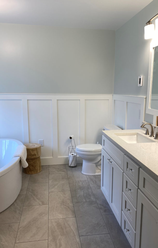 Bathroom, board and batten Extra White, walls, Benjamin Moore Ice Cap, taupe warm gray tile floor, white vanity. Kylie M