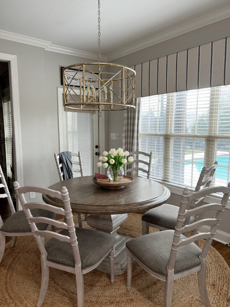 eating nook with round table, walls Sherwin Williams Agreeable Gray, trim colour Alabaster