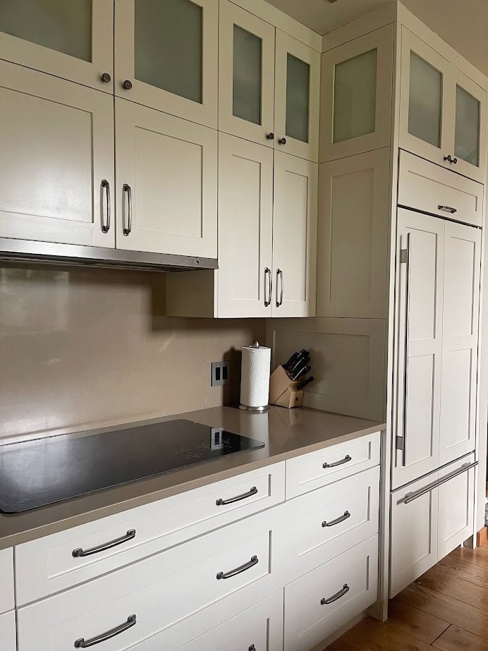 Kitchen cabinets, brown quartz countertop, cabinets painted Benjamin Moore Natural Cream paint color.
