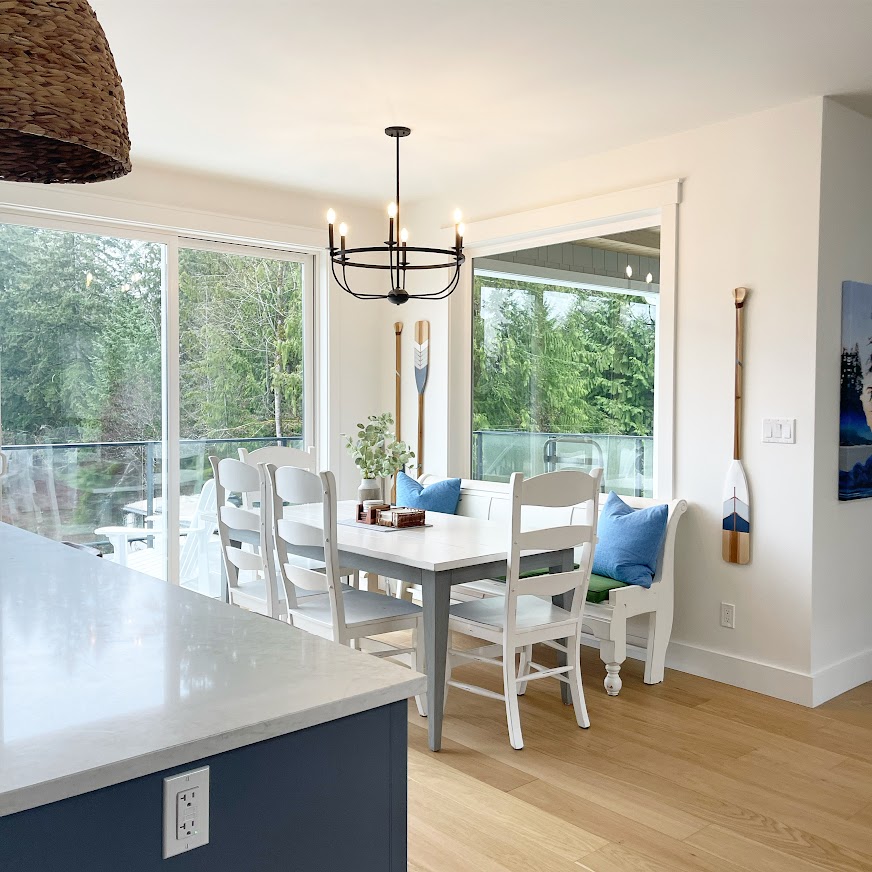Benjamin MOore White Dove in coastal, beach, lake style home with white oak floor and quartz countertop. Dining room. Kylie M Interiors online paint color expert.