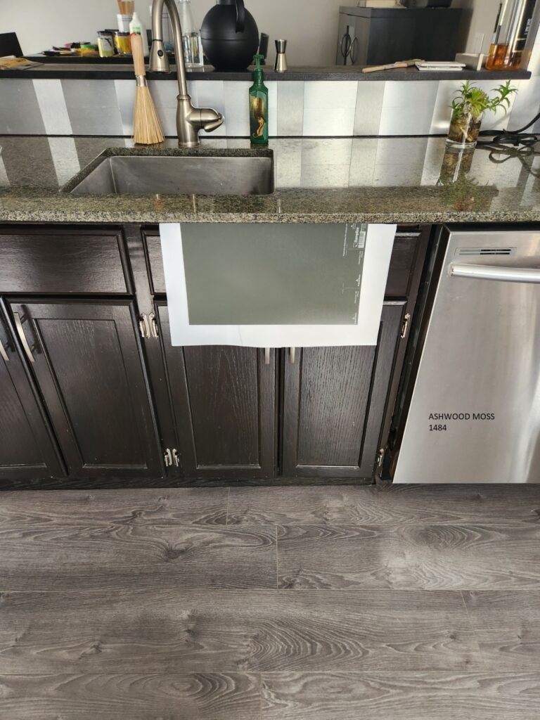Benjamin Moore Ashwood Moss green cabinet paint color with granite countertop, violet gray laminate flooring. Kylie M paint color ideas