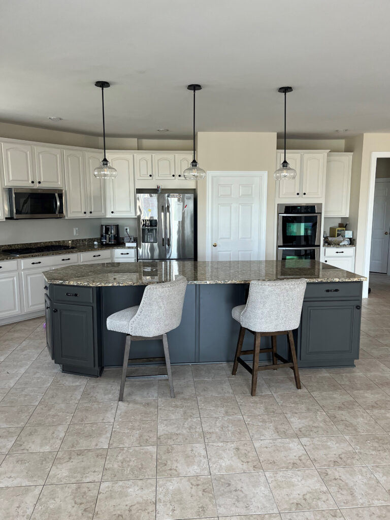 Kitchen, beige tile floor, granite Giallo Ornamental, Santa Cecelia, off-white painted beige cabinets and walls. Iron Ore island, Kylie M Edesign