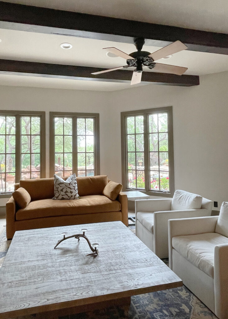 Painted tim in warm gray greige Texas Leather. Walls best off white beige, Aesthetic White. dark wood ceiling beams. Kylie M Online paint color consulting