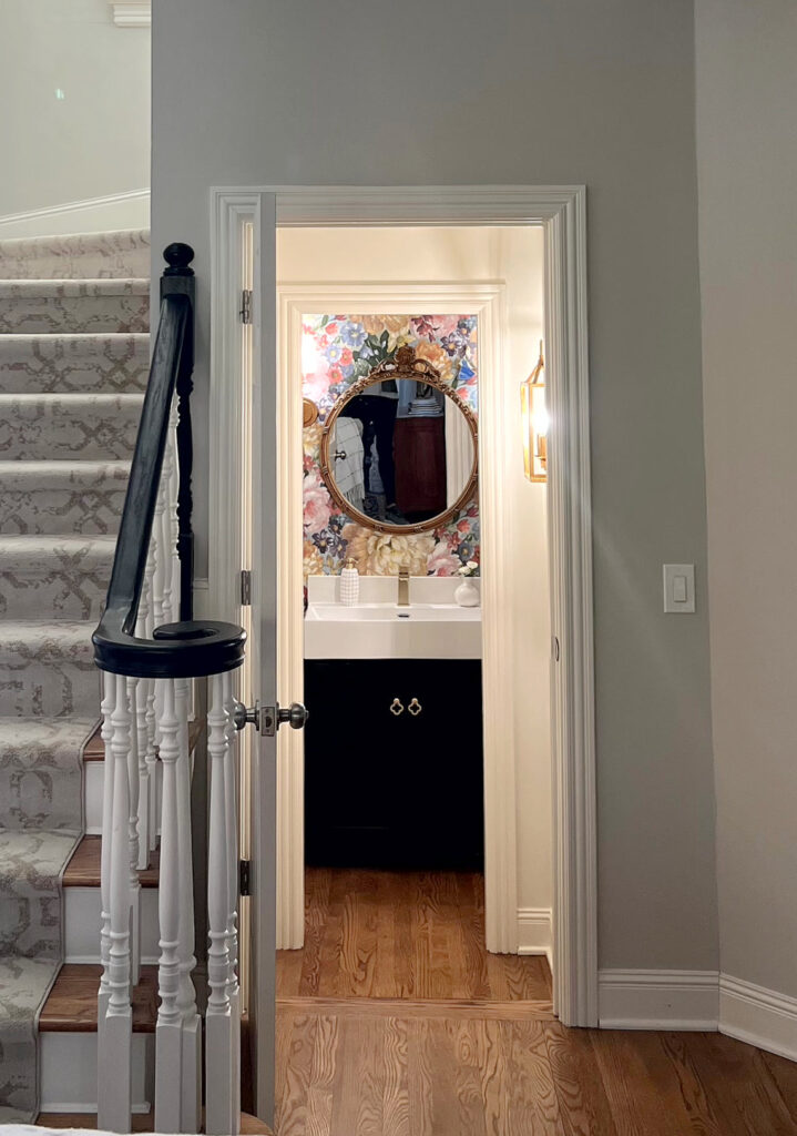 Powder room under stairs, statement floral wallpaper, dark vanity, cute small bathroom update ideas. Kylie M Client photo. Online paint color consulting