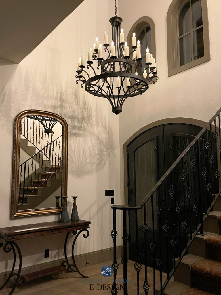 Sherwin Williams Aesthetic White, best off white beige in traditional vaulted entryway foyer, greige trim, black door, gothic style. Kylie M Interiors Edesign, wrought iron railing