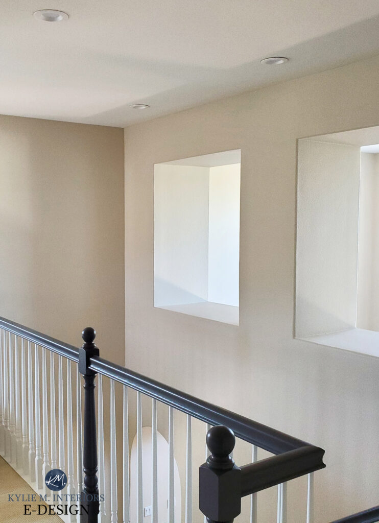 Sherwin Williams Natural Linen in staircase with white and black railings, beige carpet, walls darkened by 25 percent. Kylie M Online paint color consulting
