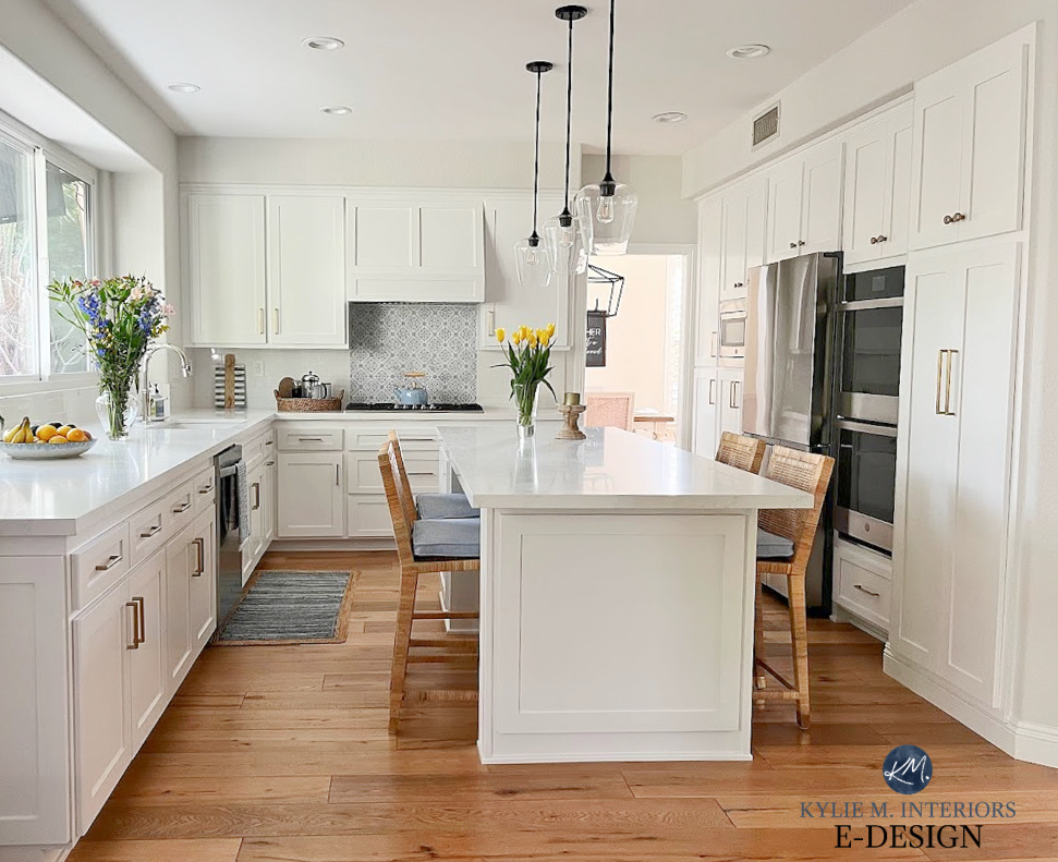 Vadara White Aura, white quartz marble look countertop, subway tile backsplash, accent tile, wood floor, island, rattan stools serena and lily, Classic Gray, stainless steel. Kylie M Interiors