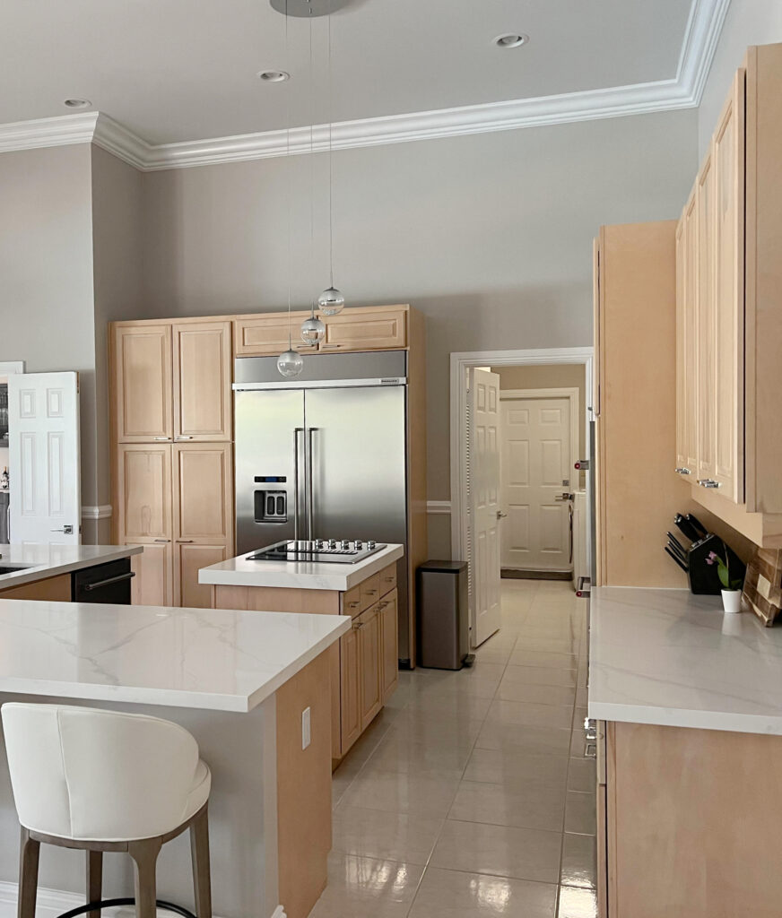 calacatta misty, modern gray, maple cabinets. Beige tile floor, stainless steel appliances