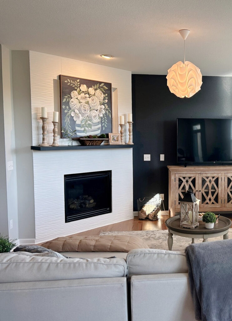 Benjamin Moore Baby Seal black paint color on accent wall behind tv, white tile on fireplace, other walls Gray Owl. Kylie M Interiors