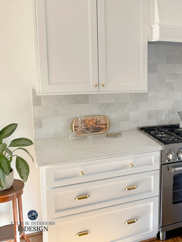 Benjamin Moore Chantilly Lace painted cabinets, MSI quartz countertop Miraggio Duo, marble subway backsplash tile, wood floor. Kylie M and Truely Co.