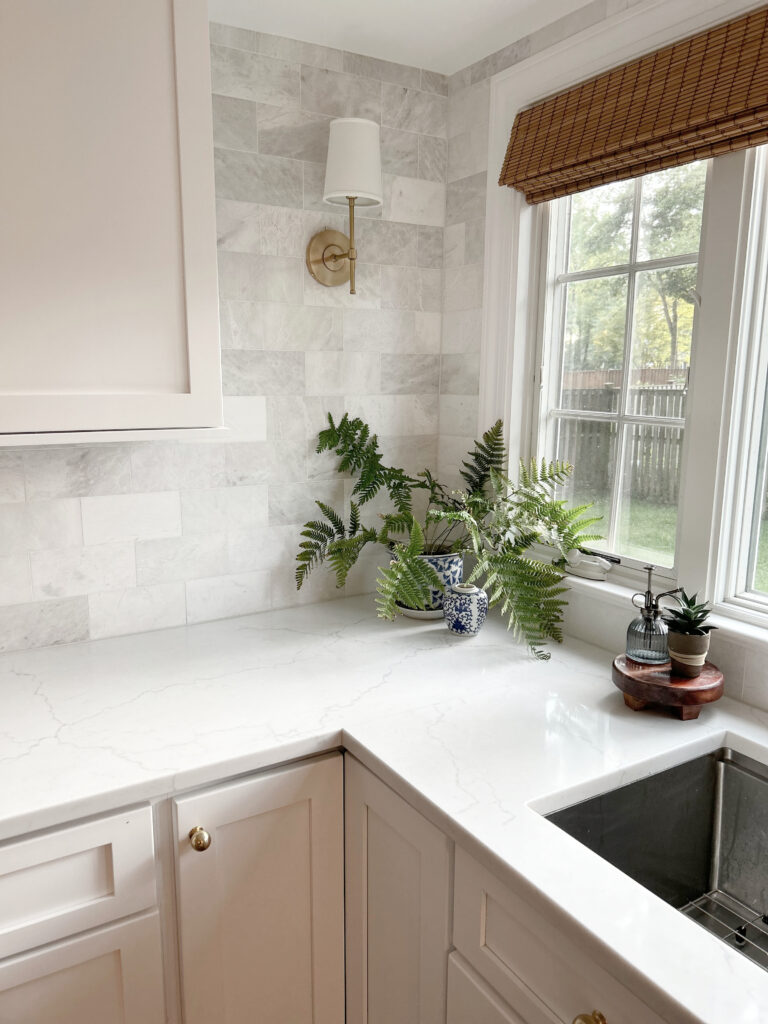 Benjamin Moore Chantilly Lace painted kitchen cabinets,MSI Miraggio Duo white quartz countertop. Wall sconce, gold brass hardware. Kylie M Online Paint Color, Truley Home colab