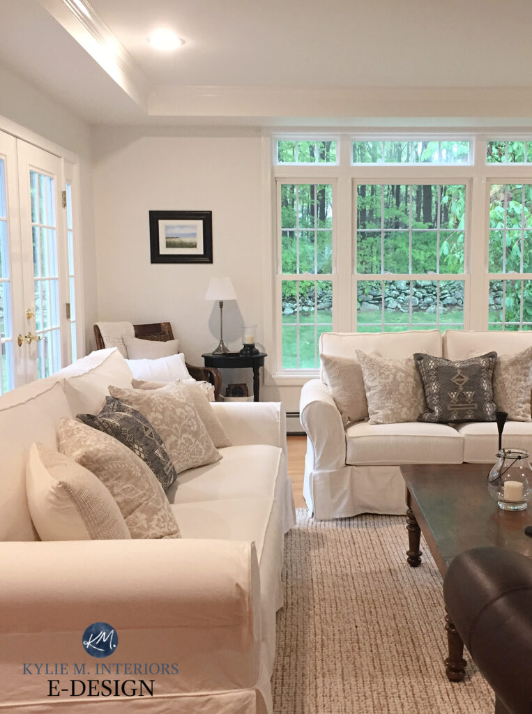 Benjamin Moore White Dove, warm white slipcovered sofas, beige area rug, wood floor. tray ceiling. Kylie M Interiors, online paint color expert
