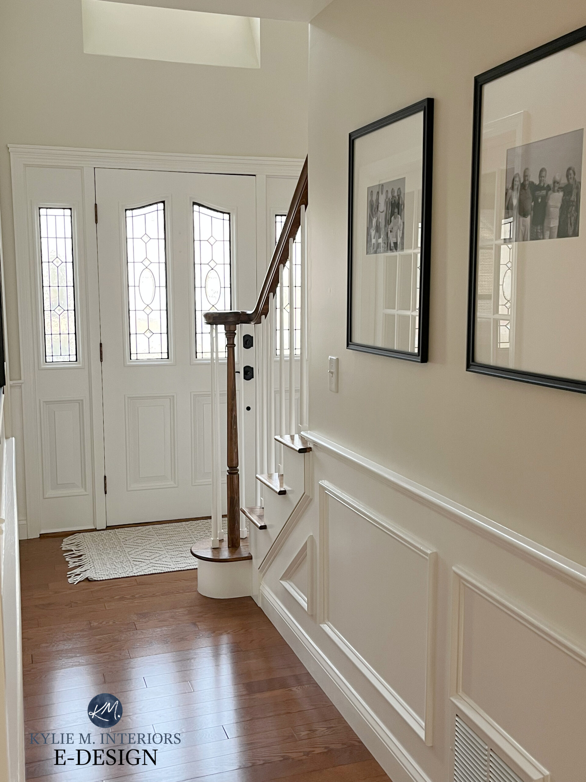 Front door in entryway, red oak stained flooring, Benjamin Moore Ballet White paint color on walls, White Dove trim.