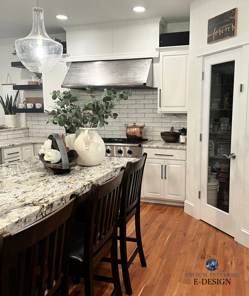 Kitchen with painted wood cherry cabinets, wood island, granite countertop, cream subway tile backsplash, wood floor. Sherwin Williams Alabaster and Creamy. Kylie M ONline paint color expert