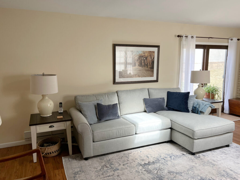 Making a palette with warm and cool colors, shown here Benjamin MOore Gentle Cream with gray sofa