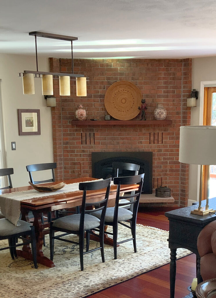 Manchester tan walls with corner brick fireplace, dining set. Red exotic cherry wood floor.