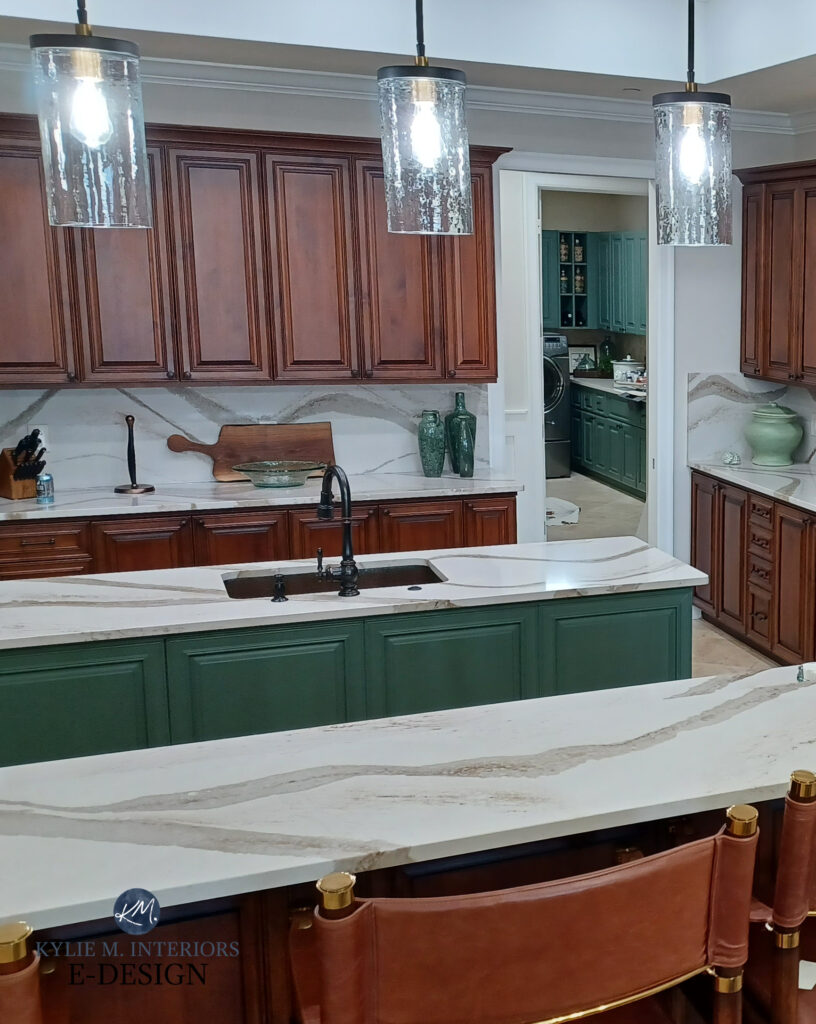 Sherwin Williams Basil green painted kitchen cabinets and island, Cambria Brittanica Gold & quartz backsplash, cherry red wood cabinets, travertine tile floor. Kylie M Interiors