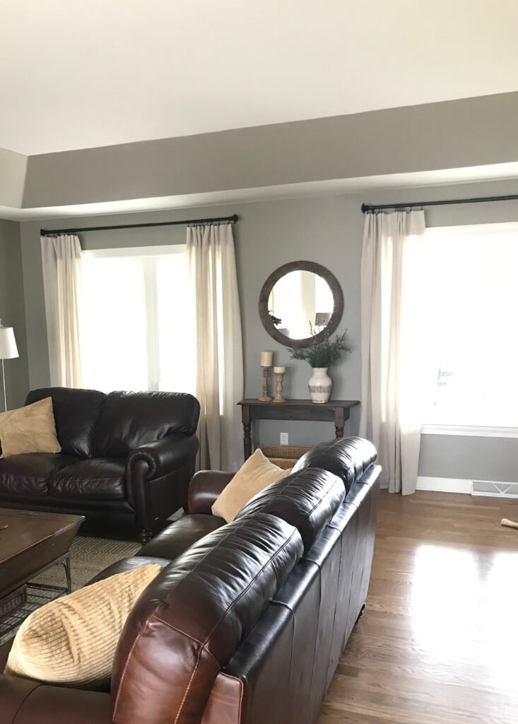Sherwin Williams Intellectual Gray in living room dark brown leather sofas, wood floor. Kylie M Interiors client photo